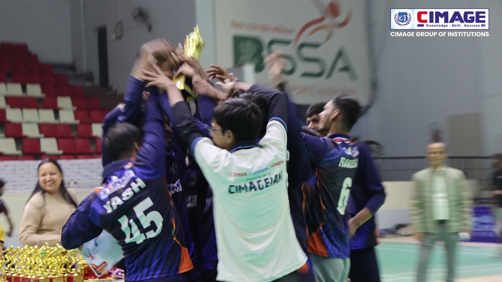 Students celebrating sports victory with a trophy