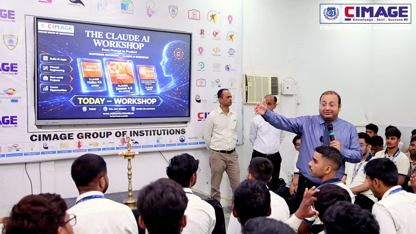 A workshop session on Claude AI in progress with a speaker and seated students.