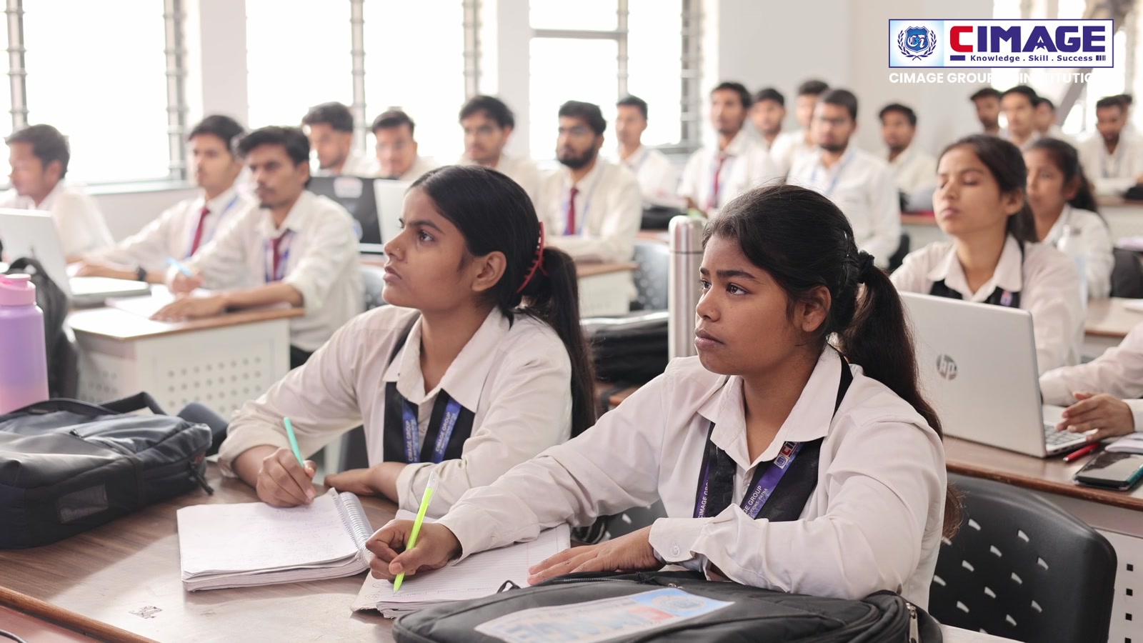 Students attentive in a classroom lecture.
