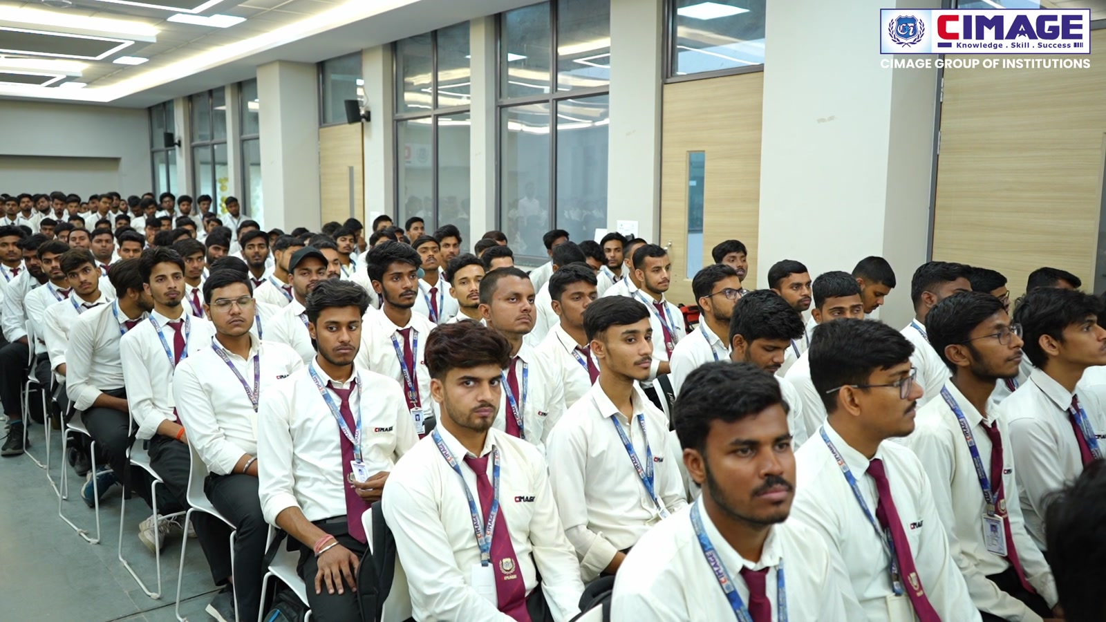 Students in uniform seated in the auditorium listening to the keynote speech.