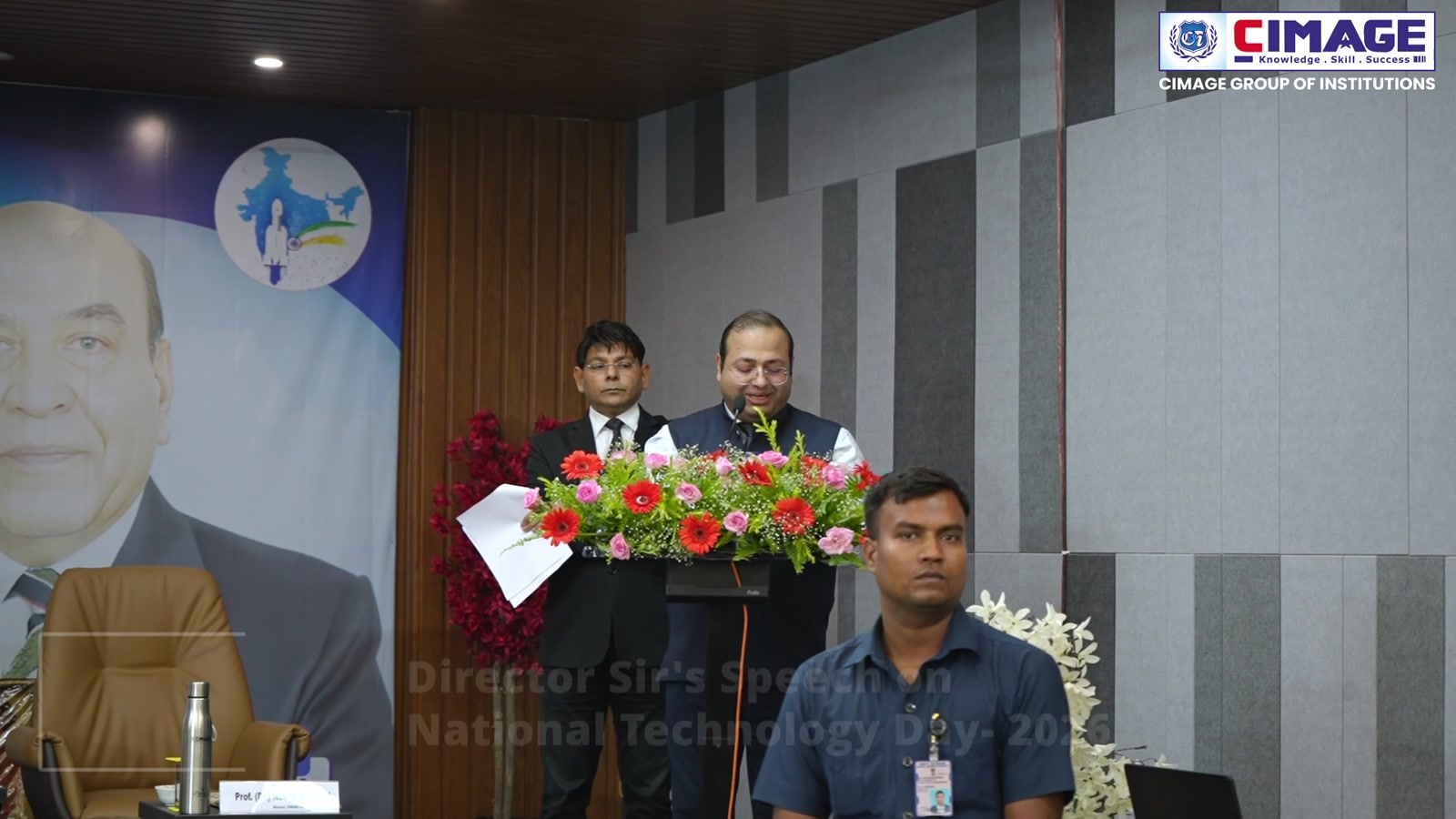 Prof. (Dr.) Neeraj Agrawal speaking at the podium during the event.
